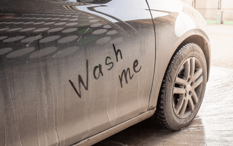 Car with "wash me" written on the side, representing why you should get a car wash