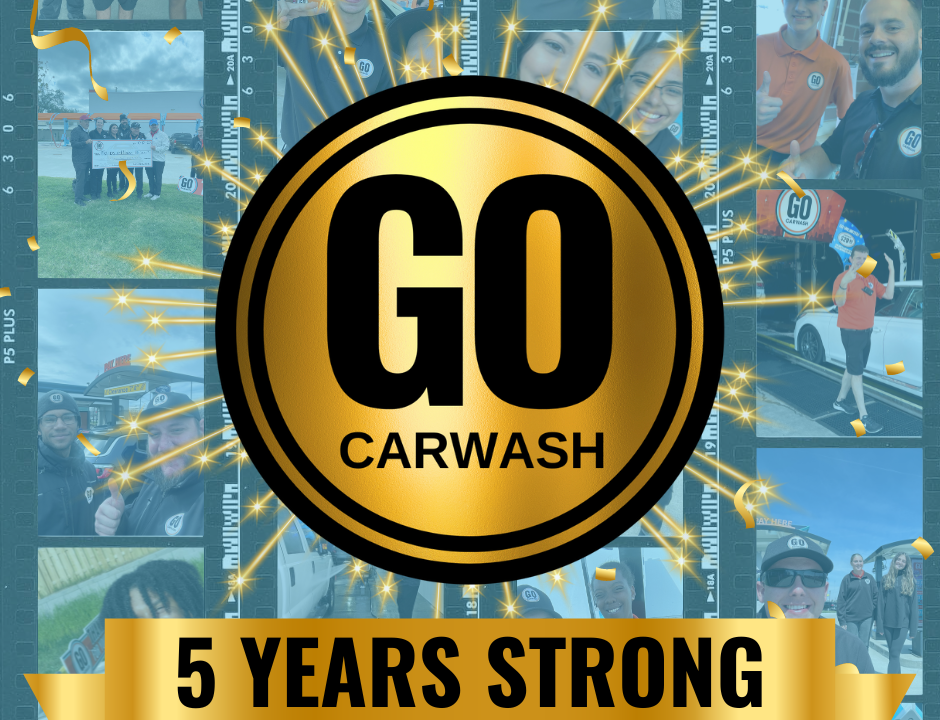 Celebratory image for GO Carwash's 5th anniversary. The image features a large gold medallion with the text "GO Carwash" in the center, surrounded by sparkling effects. Below the medallion, a gold banner reads "5 Years Strong." The background is a collage of photos showing staff and customers at various GO Carwash locations.